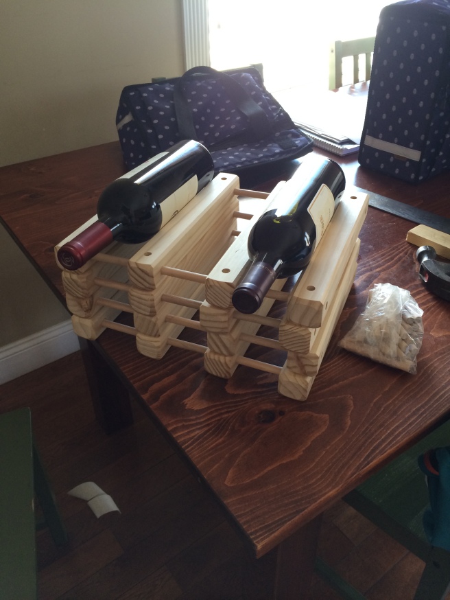Wine rack being assembled, and then we spray painted it black and put it into the lowest right hand cube.